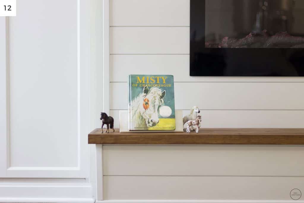 the wooden hearth provides a nice, level surface to store toys and books for kids