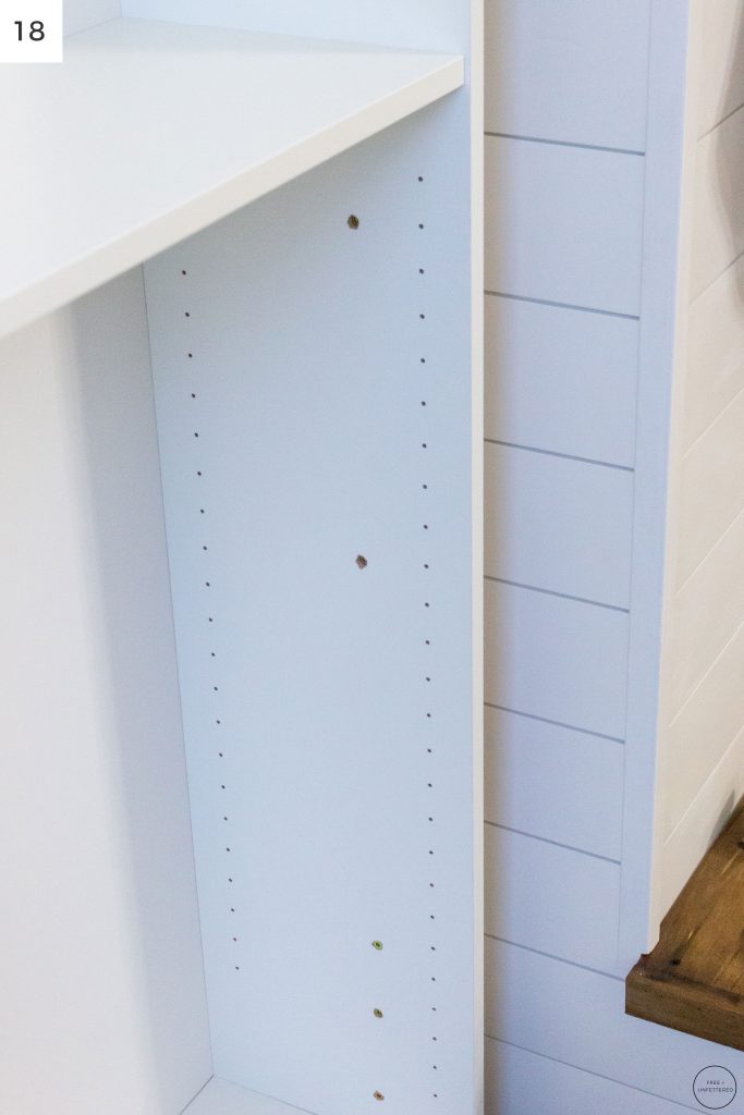 an IKEA Billy bookcase is attached to a 2x4 spacer board using several countersink screws