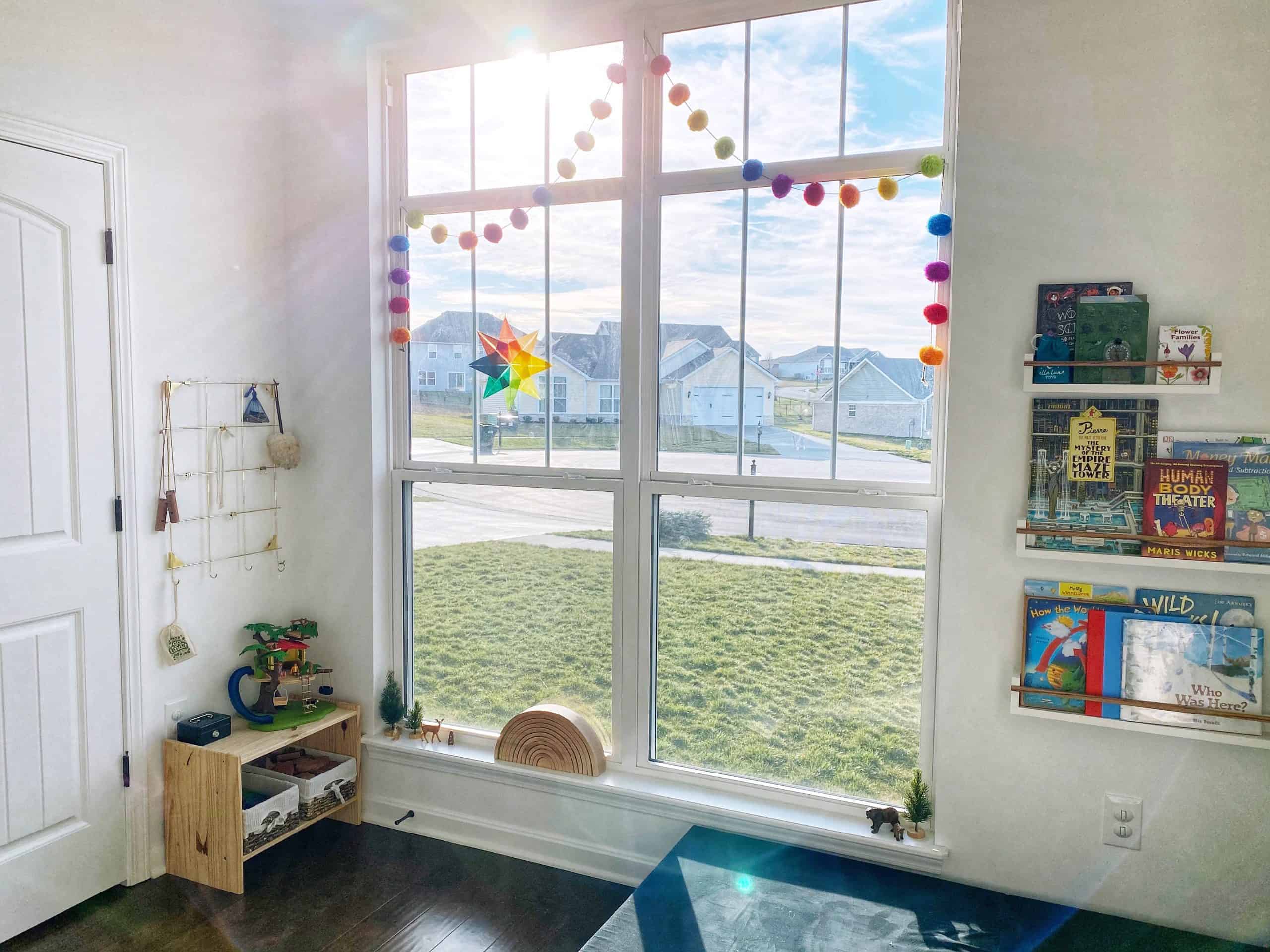 Tour a Montessori-inspired schoolroom + playroom for multiple children at www.freeandunfettered.com. You can also download a free guide to help you design your own prepared environment for your children at home. #montessori #designingspacesforchildren #preparedenvironment #montessoriathome #homeschoolroom #homeschooling 