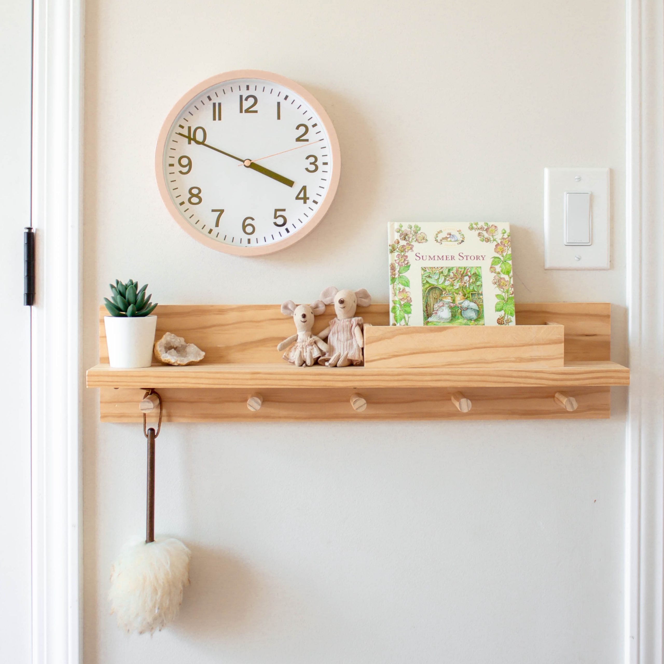 Learn how to build a wooden peg rail shelf with letter bin to help control the clutter in an entryway or bedroom area. It's a perfect small-space organization item that can be built for as little as $30 dollars! See the complete tutorial at www.freeandunfettered.com.