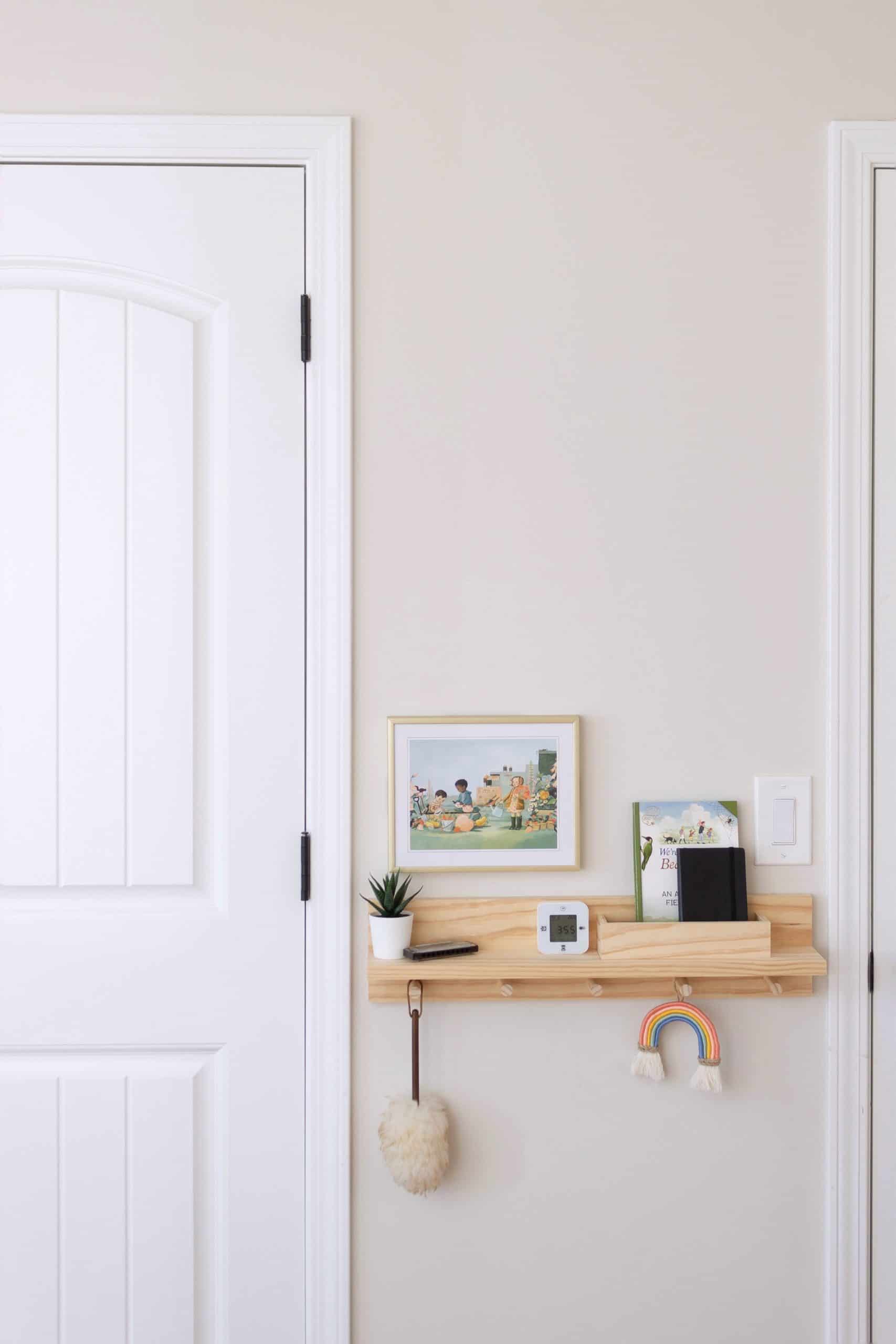 Learn how to build a wooden peg rail shelf with letter bin to help control the clutter in an entryway or bedroom area. It's a perfect small-space organization item that can be built for as little as $30 dollars! See the complete tutorial at www.freeandunfettered.com. 