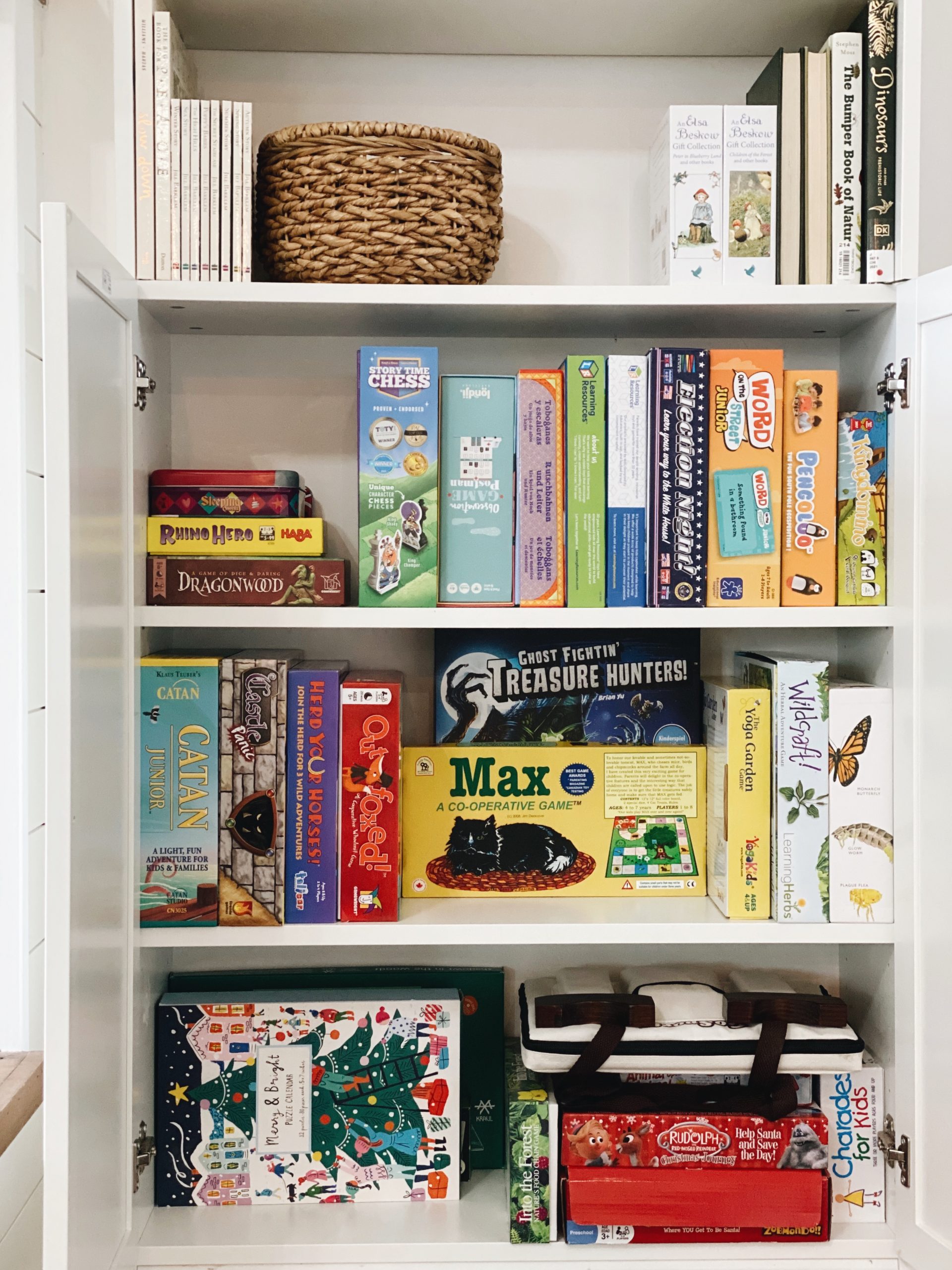 Board games are stored vertically in an IKEA Billy bookcase. 