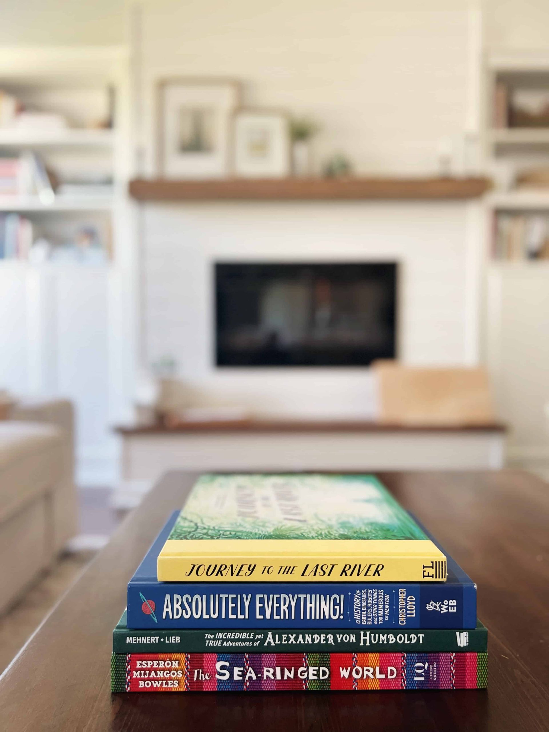 Our homeschool morning basket family read-aloud book selections this semester include Absolutely Everything by Christopher Lloyd, The Incredible Yet True Adventures of Alexander von Humboldt, Journey to the Last River, and The Sea-Ringed World: Sacred Stories of the Americas. 